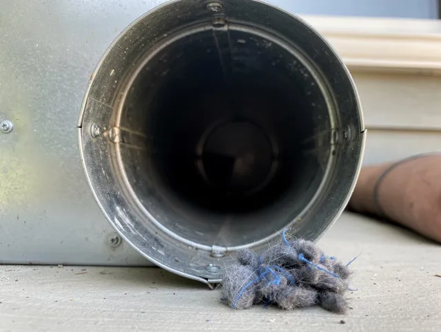 Pineville Dryer Vent Cleaning technician using specialized equipment to clear severe dryer vent blockage in Pineville